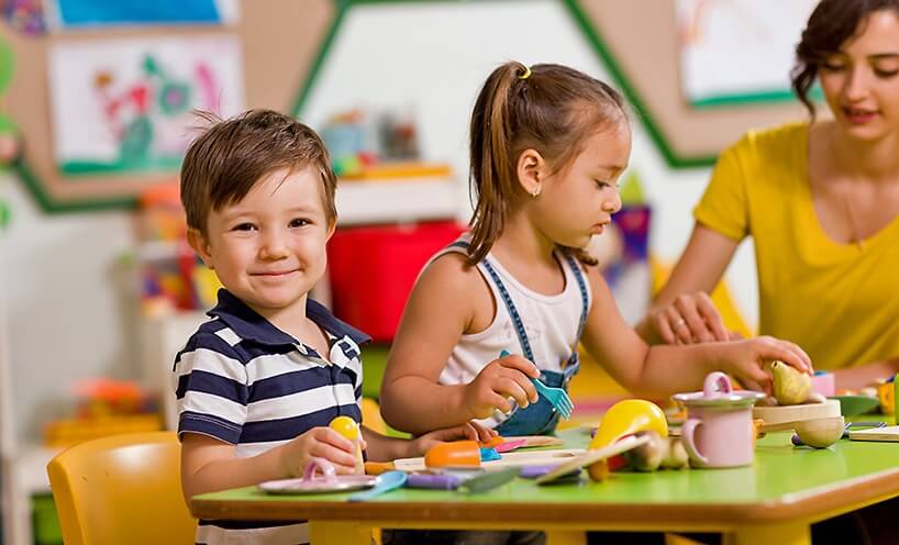 Educator with young children at an early learning centre